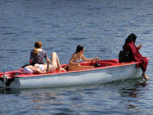 A group of women enjoy their time on a boat… even the Muslim woman is having fun. Isn’t that wild?