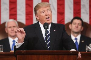 King Moron stands in front of buffoons and wows them.